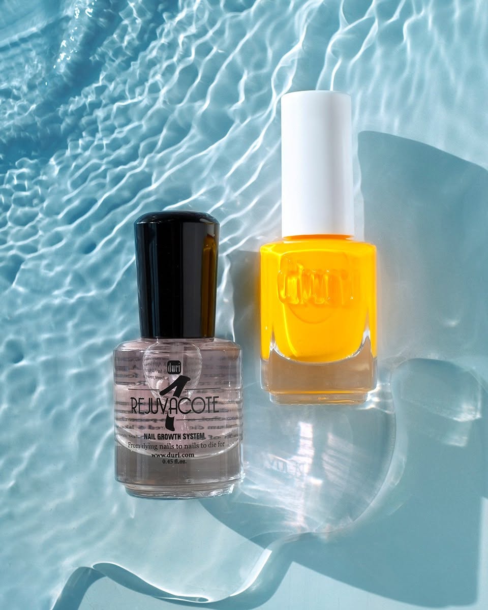 Duri Rejuvacote 1 Nail Growth System bottle next to a bottle of yellow nail polish