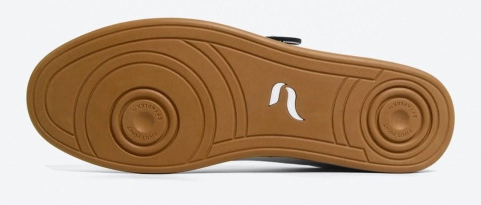 Underside of a Pulse dance sneaker showing two circular pivot points under the ball and heel of the SPYNFLEX sole