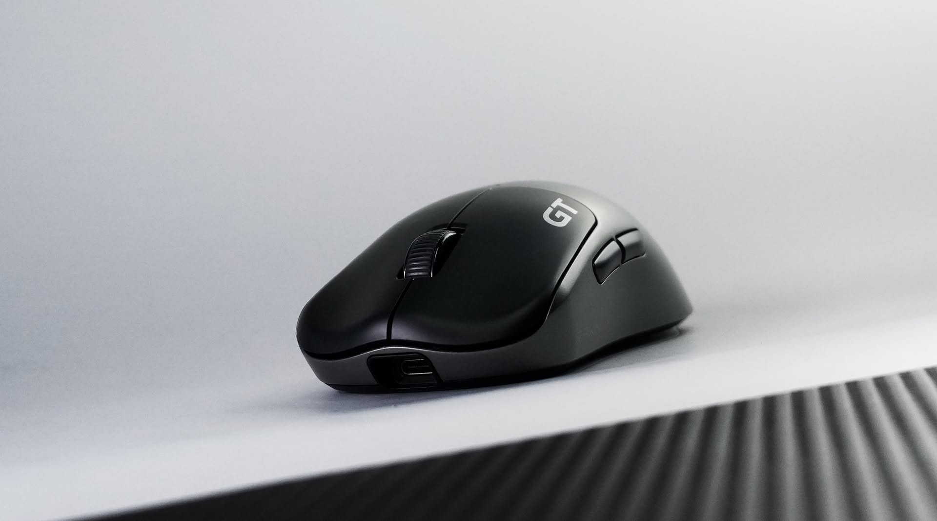 Close-up of the RAWM Leviathan V4 GT gaming mouse showing its USB-C port and GT badge